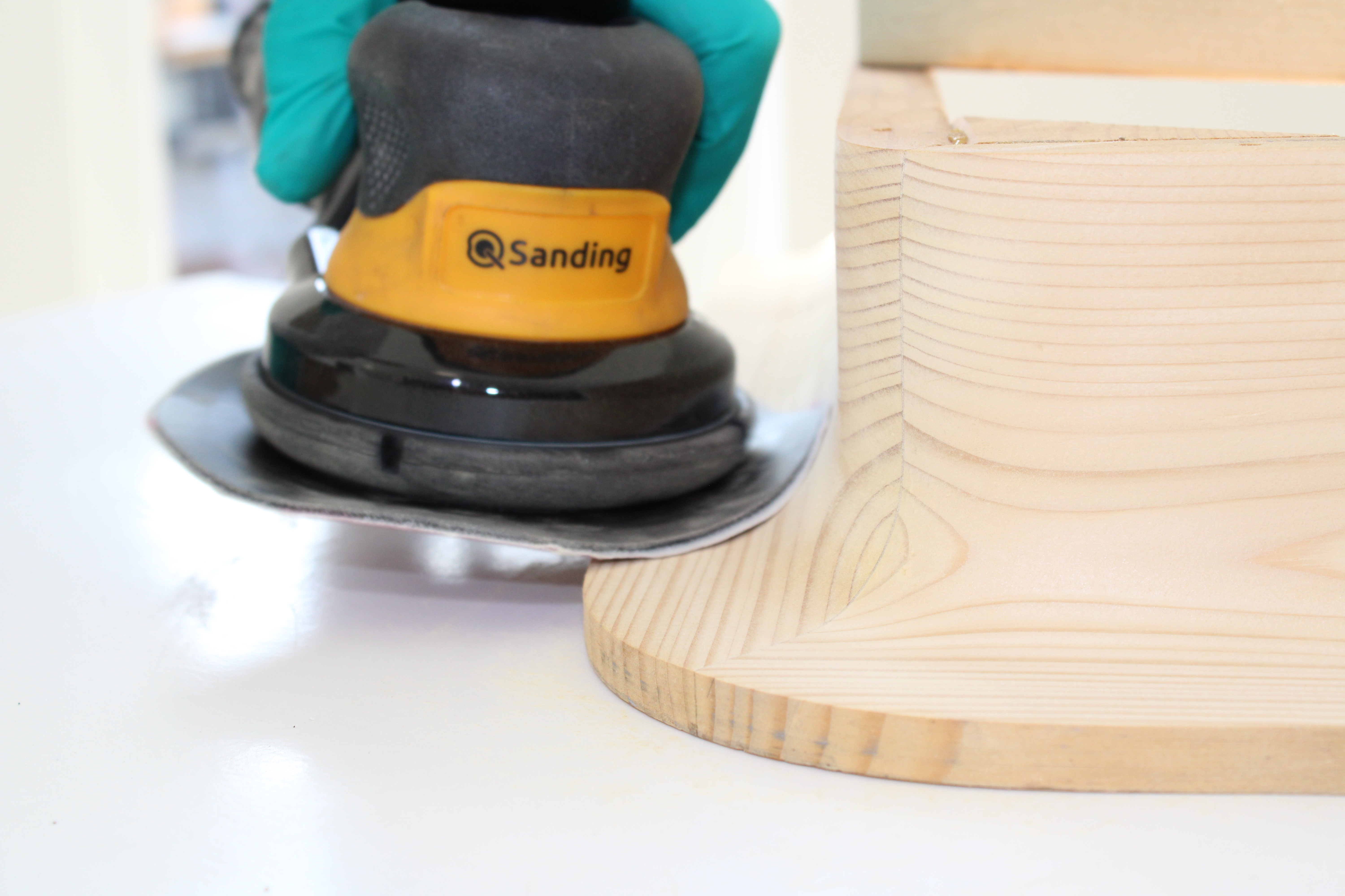 Q Sander with flexible edge on the backing pad